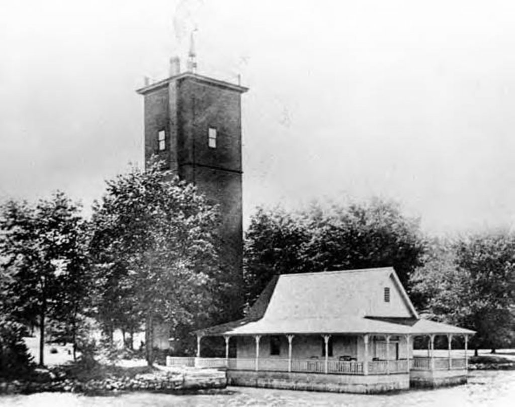 History of East Cleveland: Forest Hill Park is added to the National Register of Historic Places in 1998 | Historic photo of a lake house and tower on the park grounds